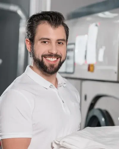 dry-cleaning-worker-holding-stack-of-clean-clothes-JV22ME2 (1)
